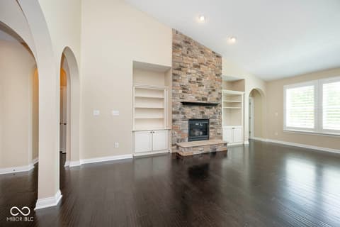 Living room at 6257 Strathaven Road, Noblesville, IN — Spacious living room with stone fireplace and built-ins.