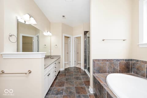 Primary bathroom at 6257 Strathaven Road, Noblesville, IN — Spacious primary bath with dual vanity and soaking tub.