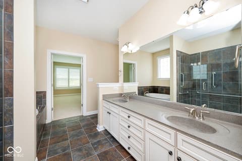 Primary bathroom at 6257 Strathaven Road, Noblesville, IN — Luxurious primary bath with dual vanity and walk-in shower.