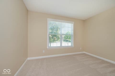Bedroom at 6257 Strathaven Road, Noblesville, IN — Bright bedroom with large shuttered window and fresh carpet.