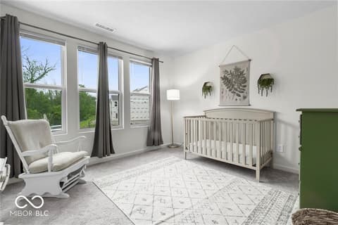 Primary bedroom at 14350 Ludwell Court, Fishers, IN — Bright nursery with expansive windows and modern finishes.