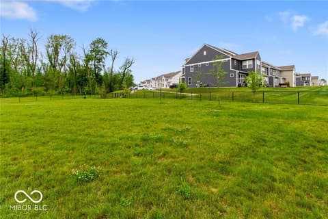Front exterior at 14350 Ludwell Court, Fishers, IN — Expansive yard with mature trees and established lawn.