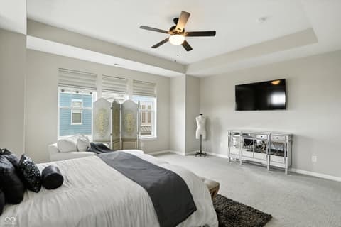 Primary bedroom at 13311 Susser Way, Fishers, IN — Spacious primary suite with tray ceiling and balcony access.