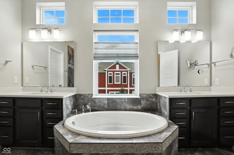 Primary bathroom at 13311 Susser Way, Fishers, IN — Spa-like primary bath with dual vanities and soaking tub.