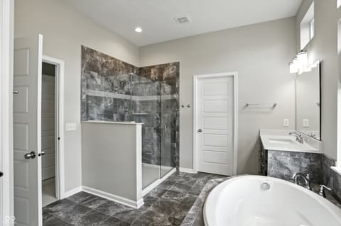 Primary bathroom at 13311 Susser Way, Fishers, IN — Luxurious primary bath with soaking tub and walk-in shower.