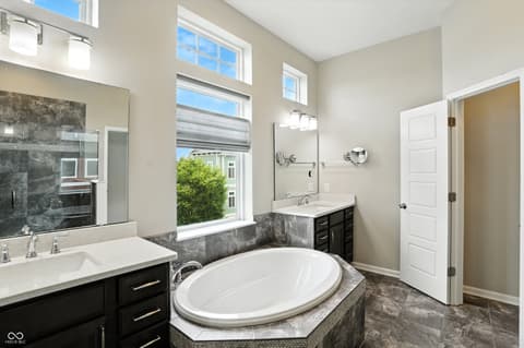Primary bathroom at 13311 Susser Way, Fishers, IN — Luxurious primary bath with soaking tub and dual vanity.