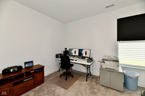 Home office at 19406 Honeylocust Glen, Noblesville, IN — Versatile office space with dual-monitor setup and storage.