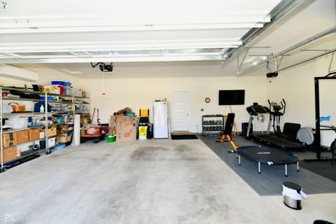 Garage at 19406 Honeylocust Glen, Noblesville, IN — Spacious garage with skylights and organized storage.