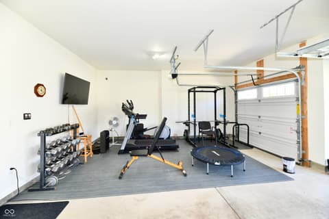 Garage at 19406 Honeylocust Glen, Noblesville, IN — Home gym-ready garage with premium equipment setup.