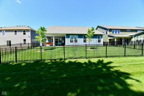 Backyard at 19406 Honeylocust Glen, Noblesville, IN — Spacious fenced yard with mature landscaping and deck.