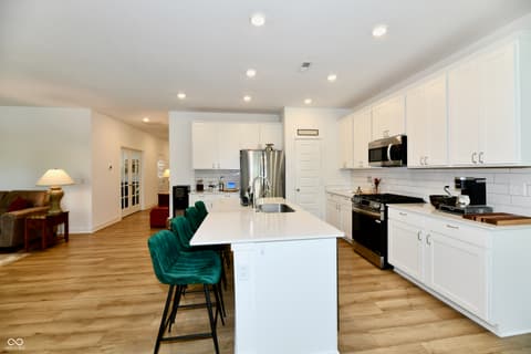 Kitchen at 19406 Honeylocust Glen, Noblesville, IN — Modern kitchen with white cabinetry and large island.