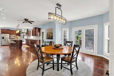 Dining room at 10587 Proposal Pointe Way, Fishers, IN — Open concept dining flows seamlessly to modern kitchen.