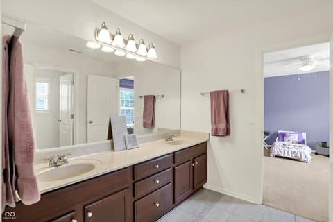 Primary bathroom at 10587 Proposal Pointe Way, Fishers, IN — Spacious primary bath with dual vanity and abundant storage.