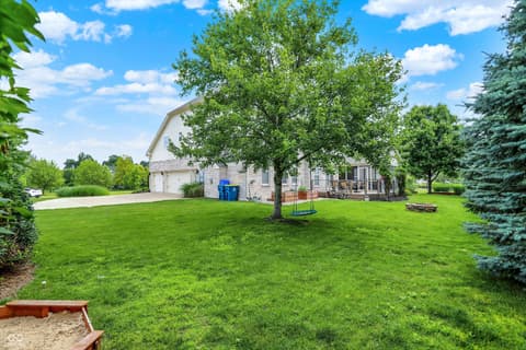 Backyard at 10587 Proposal Pointe Way, Fishers, IN — Spacious backyard with mature trees and outdoor features.