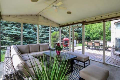 Outdoor living area at 10587 Proposal Pointe Way, Fishers, IN — Spacious screened porch with modern furnishings and views.