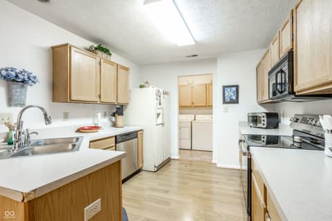 Kitchen at 9845 Worthington Boulevard, Fishers, IN — Spacious kitchen with island and laundry room connection.