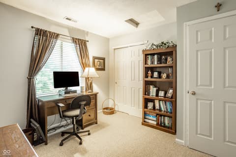 Home office at 9845 Worthington Boulevard, Fishers, IN — Bright home office with built-in bookshelves and workspace.