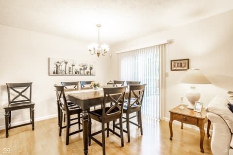 Dining room at 9845 Worthington Boulevard, Fishers, IN — Bright dining space with hardwood floors and patio access.