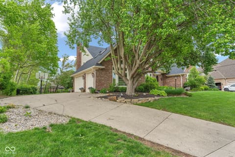 Front exterior at 3172 Smokey Ridge Lane, Carmel, IN — Charming brick home with mature landscaping and curb appeal.