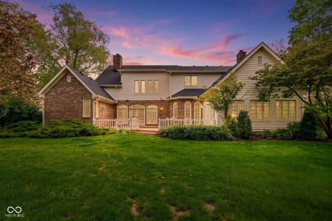Front exterior at 3172 Smokey Ridge Lane, Carmel, IN — Stunning brick and siding home with elegant front porch.