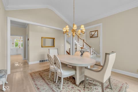 Dining room at 3172 Smokey Ridge Lane, Carmel, IN — Elegant dining room with hardwood floors and crown molding.