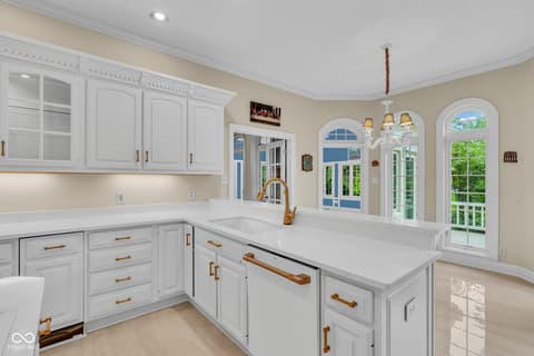 Kitchen at 3172 Smokey Ridge Lane, Carmel, IN — Bright, updated kitchen with island and arched doorways.