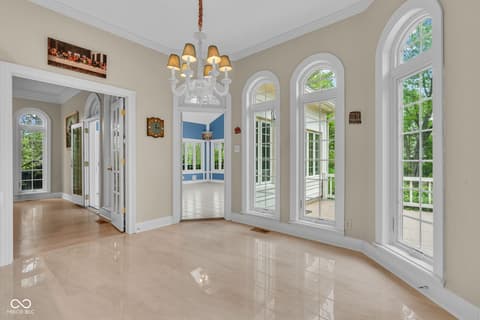 Living room at 3172 Smokey Ridge Lane, Carmel, IN — Elegant living room with marble floors and abundant windows.