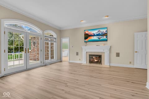 Living room at 3172 Smokey Ridge Lane, Carmel, IN — Bright living room with fireplace and deck access.