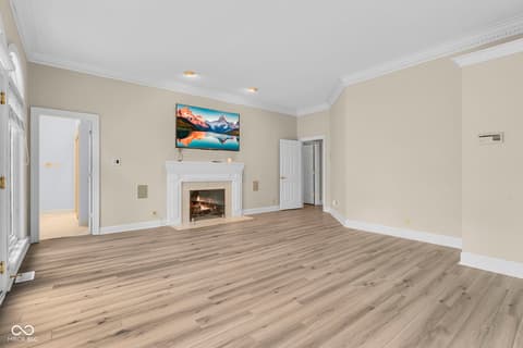 Living room at 3172 Smokey Ridge Lane, Carmel, IN — Spacious living room with fireplace and updated flooring.