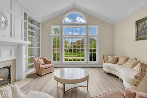 Living room at 3172 Smokey Ridge Lane, Carmel, IN — Bright living room with fireplace and expansive views.