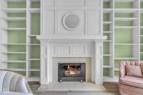 Living room at 3172 Smokey Ridge Lane, Carmel, IN — Elegant fireplace with extensive built-in shelving.