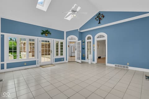 Family room at 3172 Smokey Ridge Lane, Carmel, IN — Bright, spacious room with French doors and skylights.