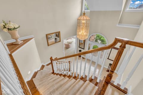 Foyer at 3172 Smokey Ridge Lane, Carmel, IN — Bright two-story foyer with skylights and hardwood stairs.
