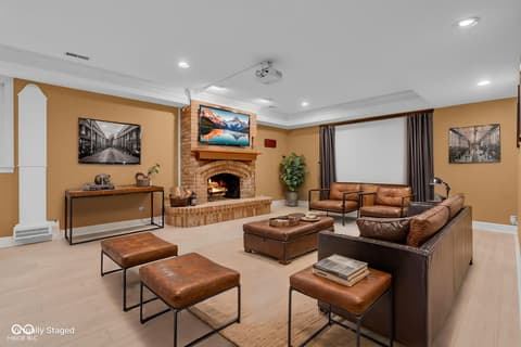 Family room at 3172 Smokey Ridge Lane, Carmel, IN — Luxurious family room with fireplace and media setup.