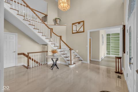 Foyer at 3172 Smokey Ridge Lane, Carmel, IN — Stunning grand foyer with elegant curved staircase.