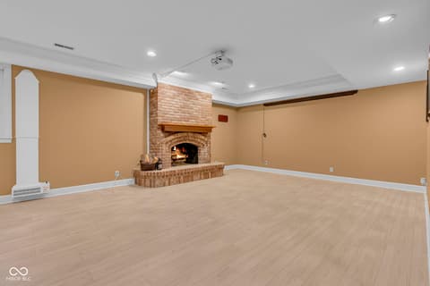 Family room at 3172 Smokey Ridge Lane, Carmel, IN — Spacious family room with charming brick fireplace.