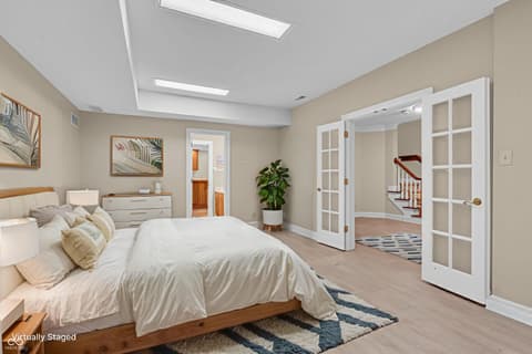 Primary bedroom at 3172 Smokey Ridge Lane, Carmel, IN — Bright primary suite with skylights and walk-in closet.