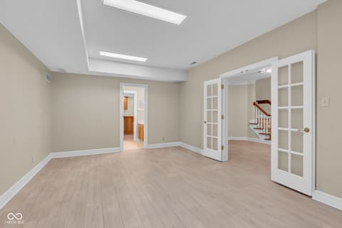 Bonus room at 3172 Smokey Ridge Lane, Carmel, IN — Bright bonus room with skylights and french doors.