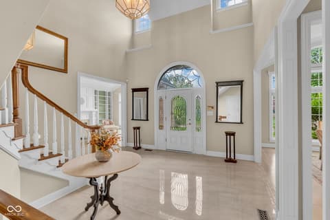 Foyer at 3172 Smokey Ridge Lane, Carmel, IN — Stunning two-story foyer with arched entry and skylights