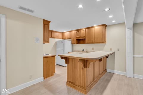 Kitchen at 3172 Smokey Ridge Lane, Carmel, IN — Spacious kitchen with wood island and ample storage.