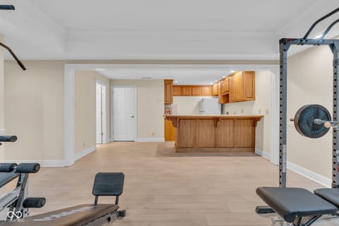 Basement at 3172 Smokey Ridge Lane, Carmel, IN — Spacious basement with wet bar and fitness area.