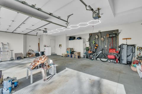 Garage at 3172 Smokey Ridge Lane, Carmel, IN — Modern garage with epoxy flooring and smart lighting.