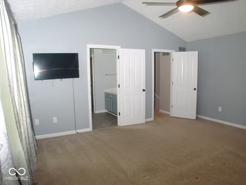 Bonus room at 7623 Willow Ridge, Fishers, IN — Spacious bonus room with vaulted ceiling and ample storage.