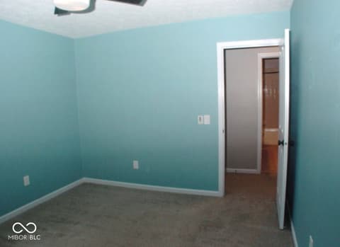 Bedroom at 7623 Willow Ridge, Fishers, IN — Bright turquoise bedroom with fresh paint and carpet.