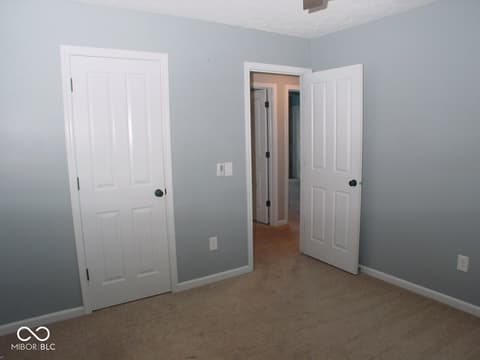 Bedroom at 7623 Willow Ridge, Fishers, IN — Spacious bedroom with multiple closets and neutral finishes.