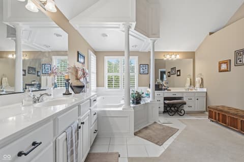 Primary bathroom at 13221 Griffin Run, Carmel, IN — Luxurious primary bath with dual vanities and soaking tub.