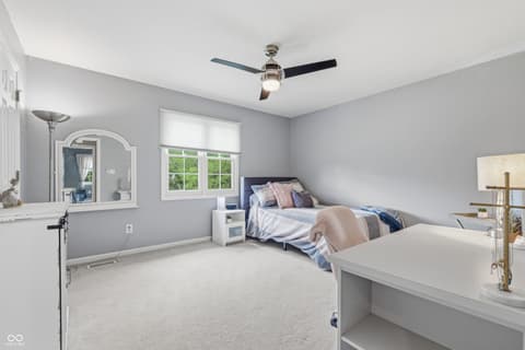 Primary bedroom at 13221 Griffin Run, Carmel, IN — Bright primary suite with ensuite bath and workspace.