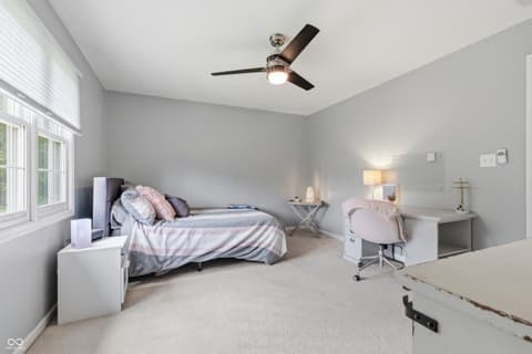 Bedroom at 13221 Griffin Run, Carmel, IN — Spacious bedroom with work area and abundant natural light.