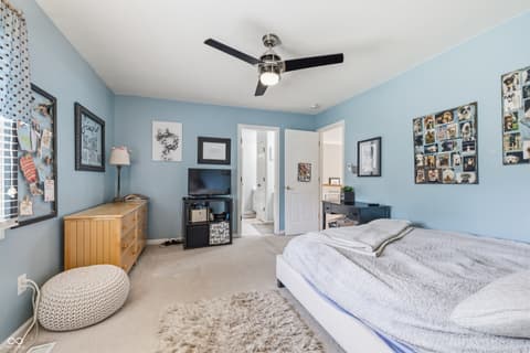 Bedroom at 13221 Griffin Run, Carmel, IN — Bright spacious bedroom with entertainment area and storage.