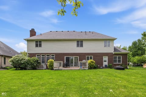 Backyard at 13221 Griffin Run, Carmel, IN — Spacious brick colonial with manicured yard and deck.